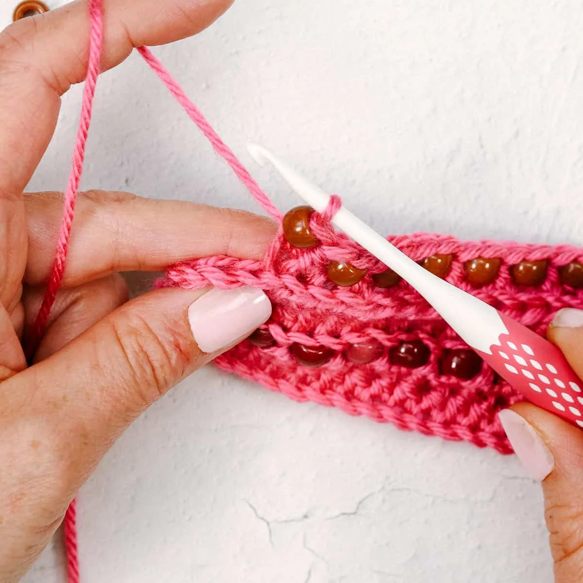 Tutorial on how to pull through first loop, bead and second loop.