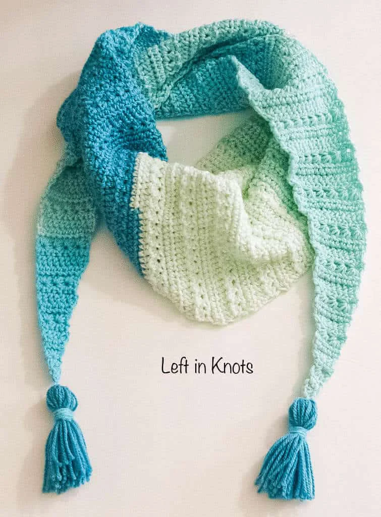 A modern crochet triangle scarf made with the star stitch