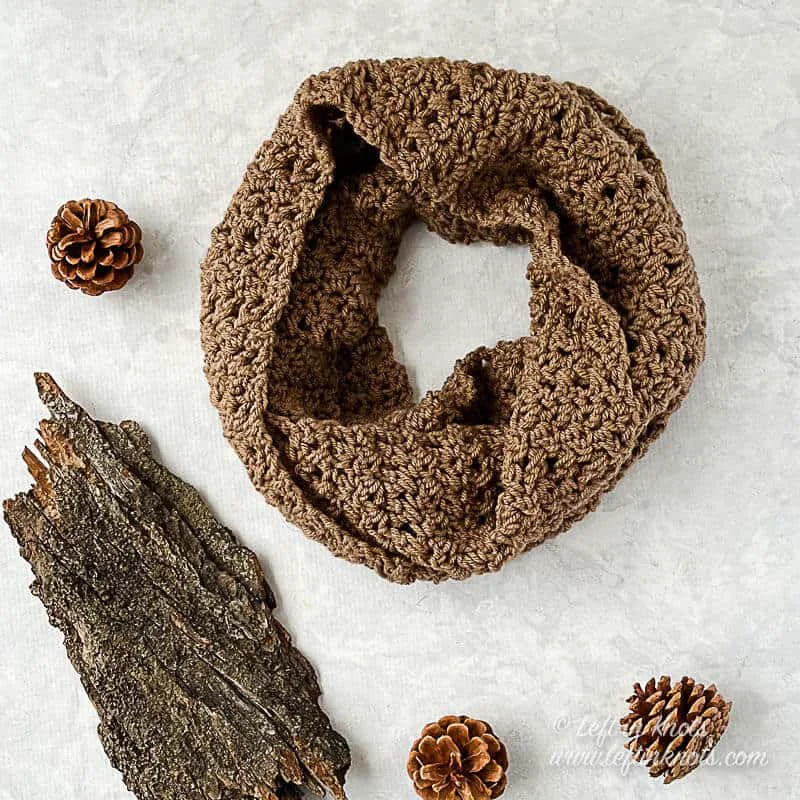 A taupe colored crochet infinity scarf