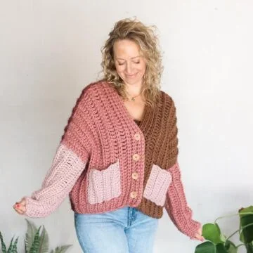Oversized color-block crochet cardigan with buttons on a middle-aged woman.