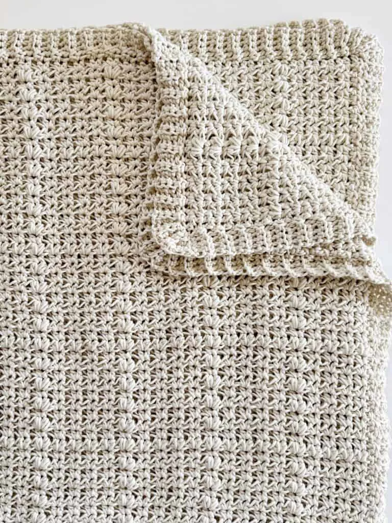 close up of folded crochet blanket 
