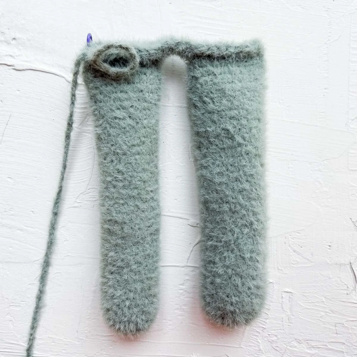 Long legs connected by crochet stitches to form the beginning of the bunny body.