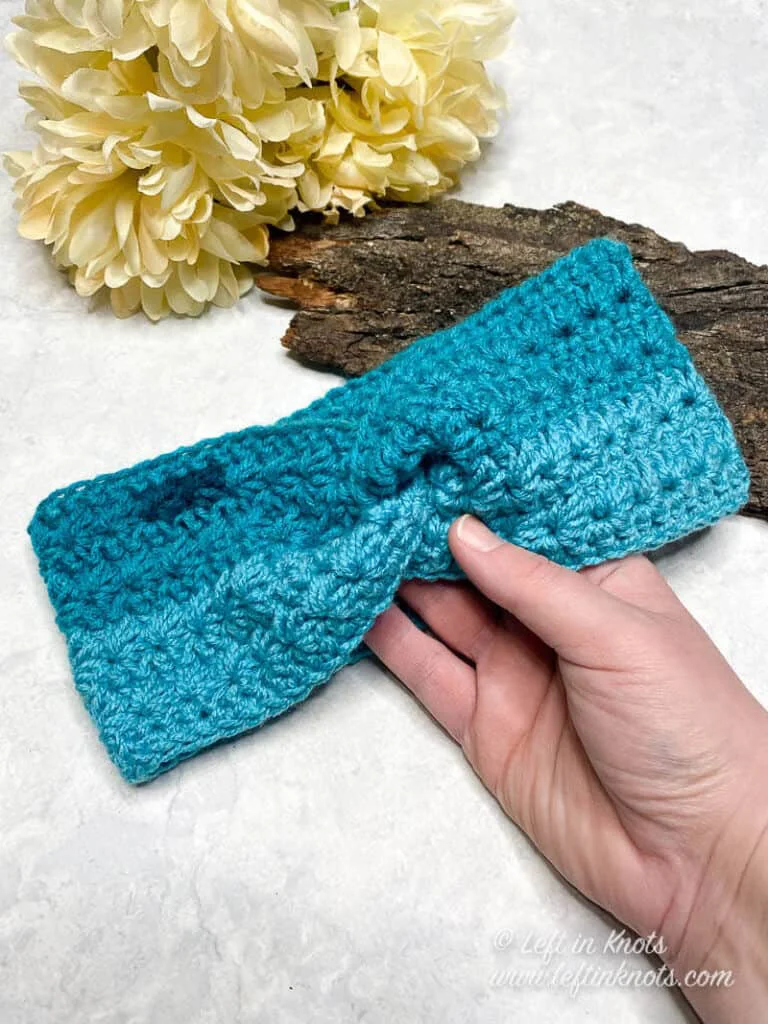 Turquoise crochet ear warmer made with the star stitch