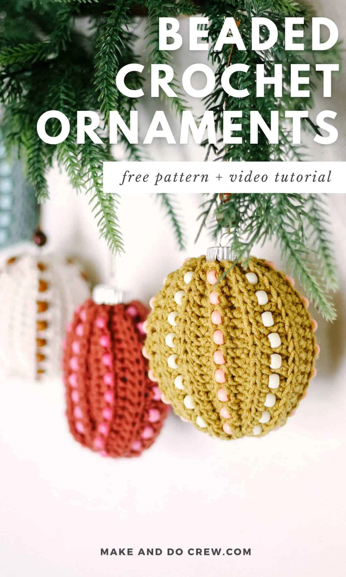 Beaded crochet ornaments hung on a tree branch.