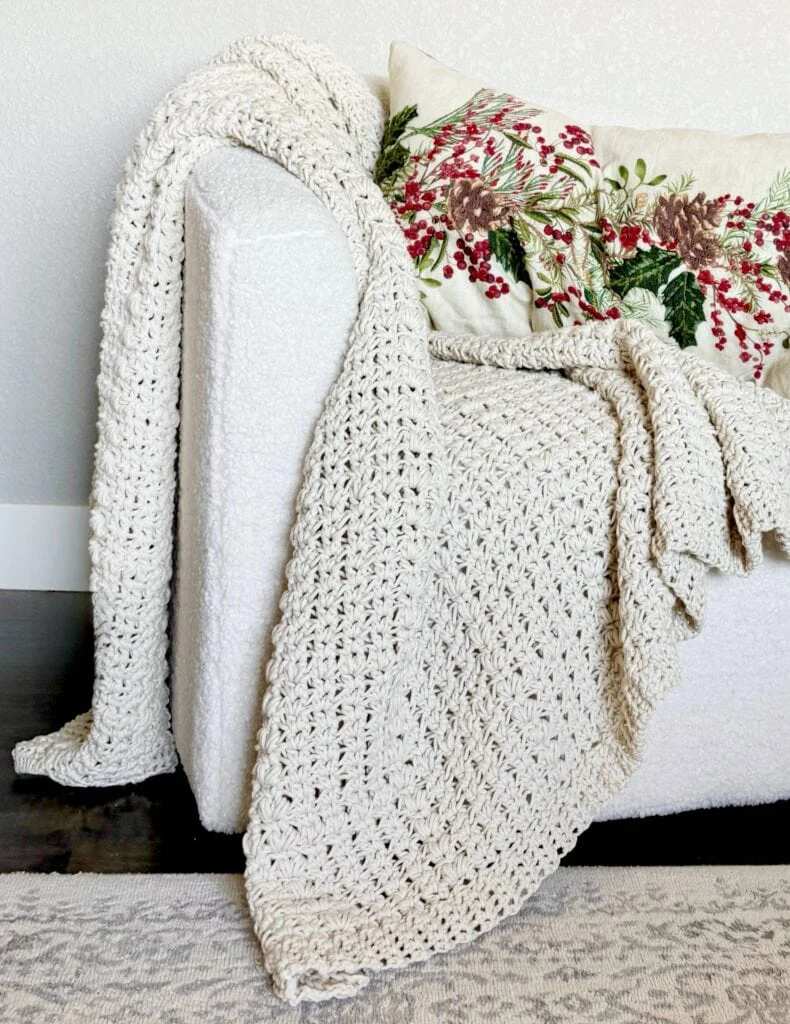 crochet throw draped over chair with pillow