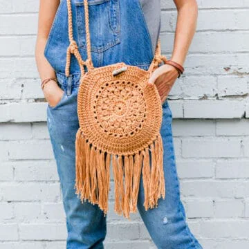 This easy crochet hippie purse pattern is made from Lion Brand 24/7 Cotton yarn and two simple circles. Great bag for adding boho style to your handmade wardrobe.