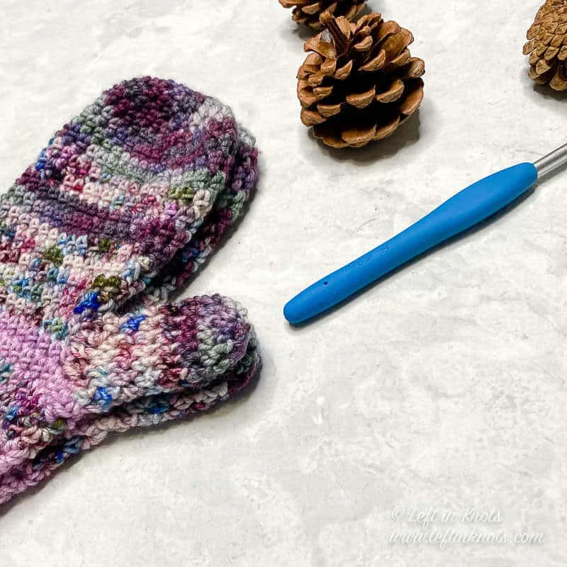 Mittens crocheted with hand dyed yarn in shades of purple