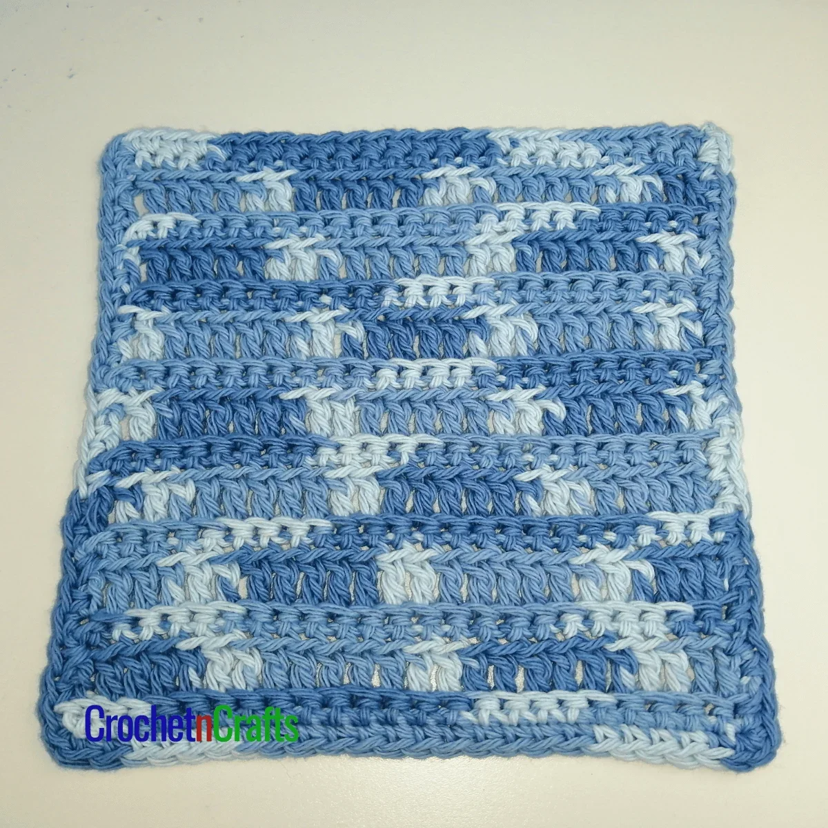 Crochet ribbed dishcloth laid flat.