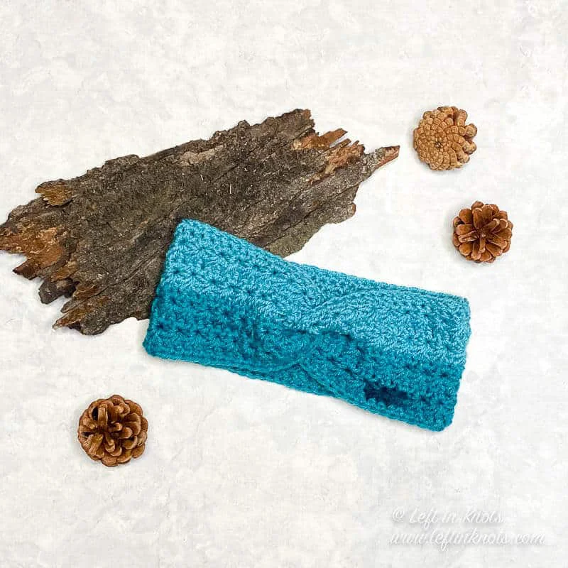 Turquoise crochet ear warmer made with the star stitch