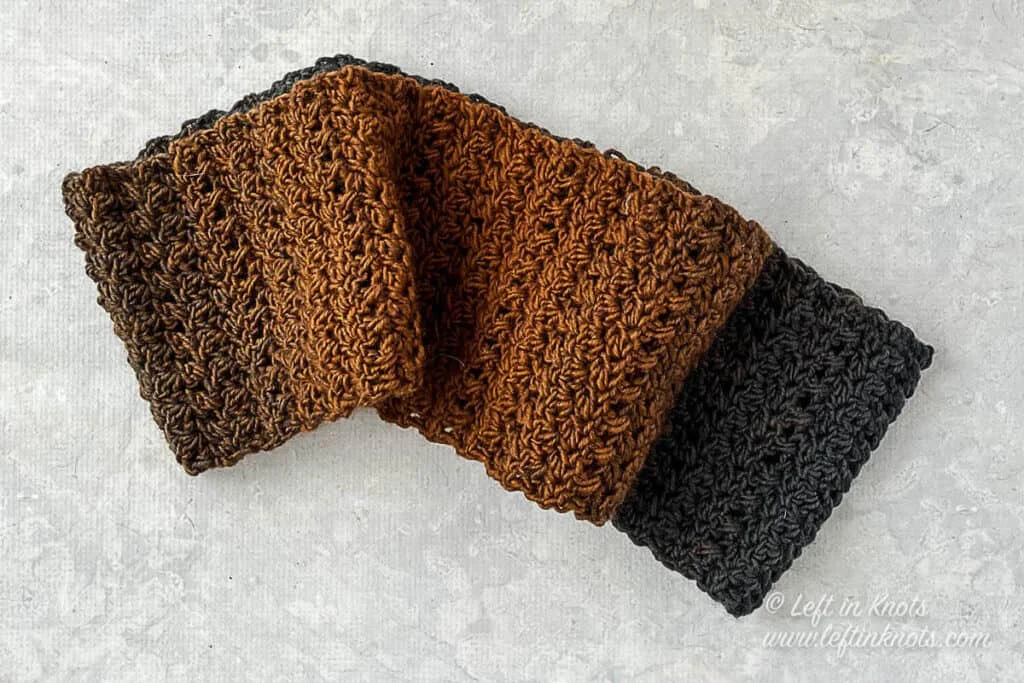 A black and rust colored crochet infinity scarf